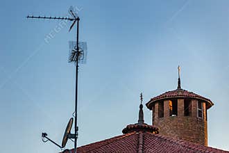 TV antenna, satellite dish and Catholics Cross
