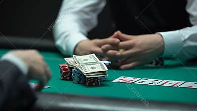 Risky poker player going all-in, betting money and house keys, addiction