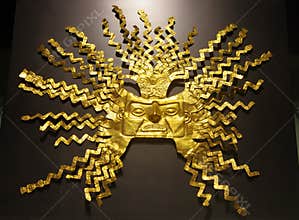 QUITO, ECUADOR - AUGUST 24, 2018: Close up of beautiful golden Inca mask inside of el Agora museum located in Casa de la