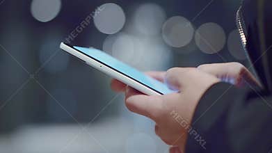 Close up of women`s hands holding cell phone.