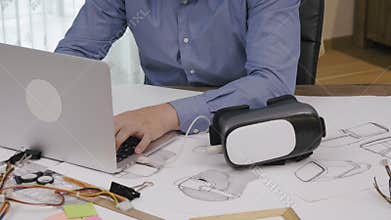 Software engineer programming VR headset