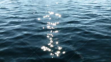 Sparkling wavy water is shining on a sunny summer day