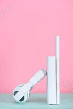 headphones leaning on white books on table