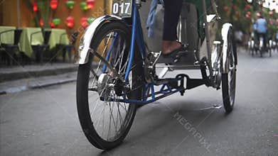 Hoi An, Vietnam - May 10, 2018: Rickshaw drive the chinese tourists along the ancient street in old town in Hoian