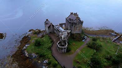 Flight over famous Eilean Donan Castle in the Highlands of Scotland - aerial drone footage