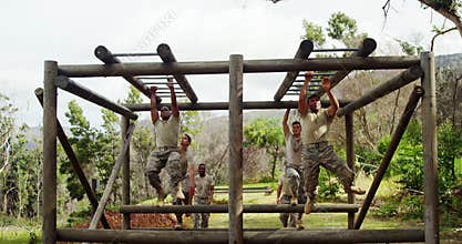 Military soldiers climbing monkey bars 4k