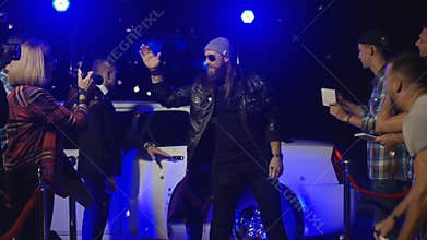 Rock band walking on red carpet