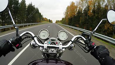4K. Fast motorcycle riding on the beautiful forested road, wide point of view of rider. Classic cruiser/chopper forever!