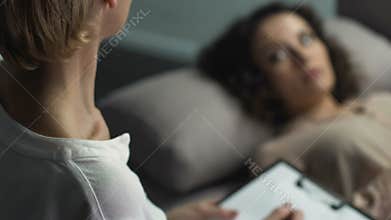 Experienced psychologist listening to patient trying to understand her condition