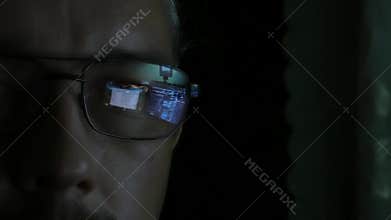 Programmer or hacker - software code reflecting in the glass