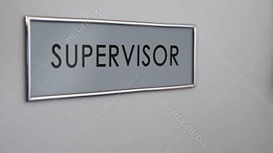 Supervisor office door, hand knocking closeup, work quality control, authority