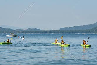 Lindell Beach, Canada - July 28, 2018: kids on kayaks enjoy Sunny day at Cultus Lake near Chilliwack Canada.