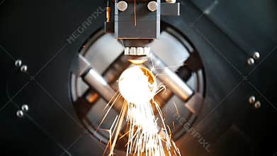 Cutting of metal, sparks fly from laser, modern tool in heavy industry.