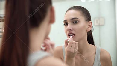 Makeup. Woman Applying Liquid Lipstick On Lips At Bathroom