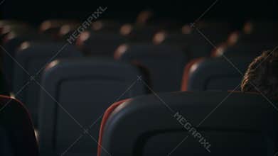 Cinema couple in love. Romantic date in movie theater. Kissing couple