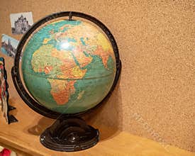 Rustic world globe displaying Africa and Europe in a child`s room