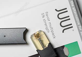 Box holding JUUL nicotine dispenser and pods