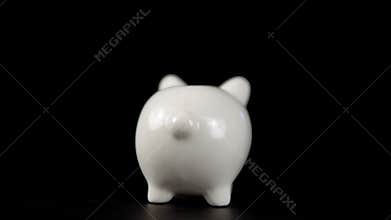 The concept of charity during the movember, someone puts a coin in piggy bank.
