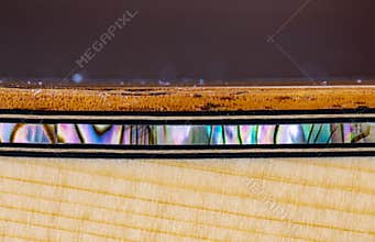 Pau Abalone sea shell inlay on the koa binding of a guitar