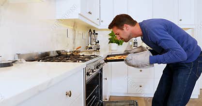 Man taking pizza from oven 4k