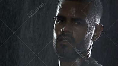 Athlete serious face under rain drops during outdoor competition, leader nature