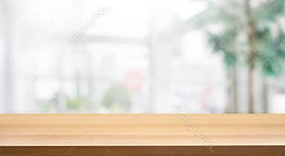 Wood table top on blur white glass wall background form office building