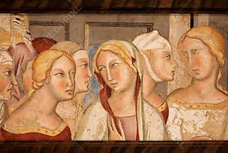 Female heads on 14th century fresco inside historical Palazzo del Podesta