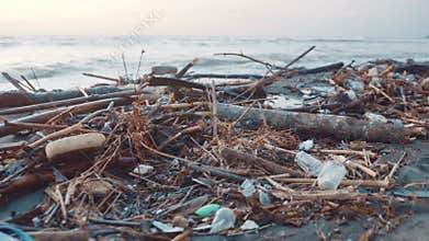 Plastic bottles and other garbage dumped on black beach. Environmental pollution
