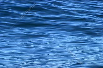 Beautiful calm ripples on deep blue ocean
