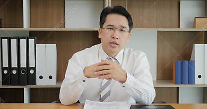 Attractive Asian man recording video message talking on webcam, consultant making offer to client by video call, vlogger
