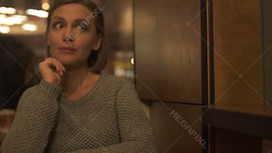 Nervous woman sitting in cafeteria waiting for boyfriend, blind date service