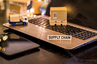 Logistics Supply Chain Challenges - still life logistics business concept with laptop, phone, mini shipping cartons