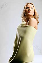 Young blond woman wrapped in light-yellow cloth