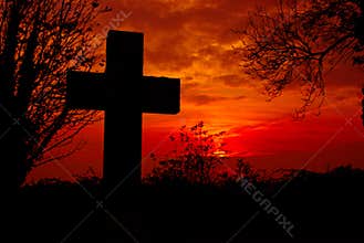 Cross with red sky background.