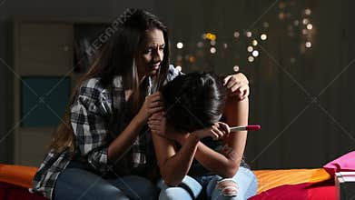 Girl comforting her sad pregnant teenage friend