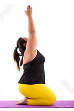 Studio shot of young fat Asian woman sitting while doing yoga po