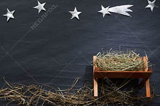 Manger and star of Bethlehem abstracy christmas background nativity scene on black marble