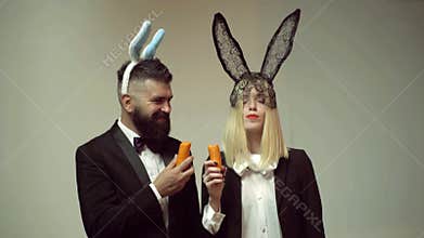 Funny couple rabbit eat carrot. Bunny ears concept with bunny couple. Heppy easter couple.