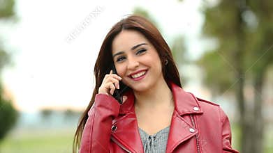 Woman calling on phone looking at you slow motion