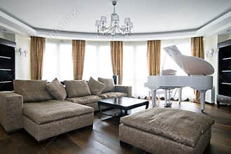Interior of light living room with white piano