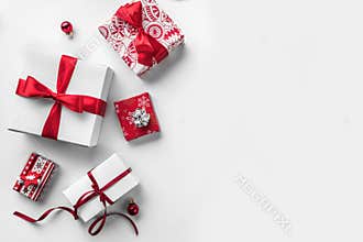 Christmas gift boxes with red ribbon and decoration on white background.