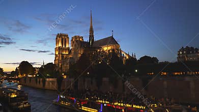 Notre dame cathedral and a river tour boat, paris