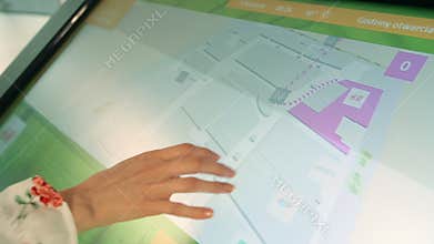 Anonymous woman using navigation board in mall.