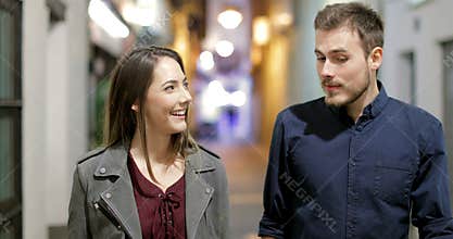 Couple meeting and talking in the street in the night