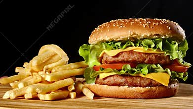 Craft beef burger and french fries, sauce isolated on black background. fast food