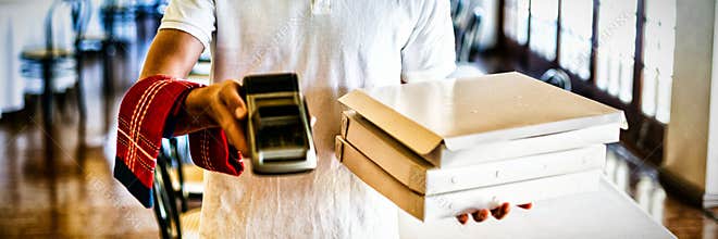 Happy pizza delivery man showing card reader