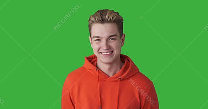 Handsome young man against green background