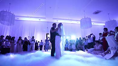 First dance of stylish wedding couple. Handsome groom and elegant bride in the restaurant