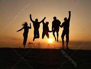 Sunset friends jumping