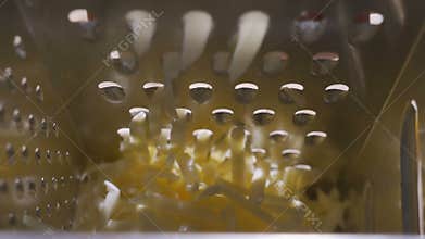 Cheese grater full closeup with cheddar cheese